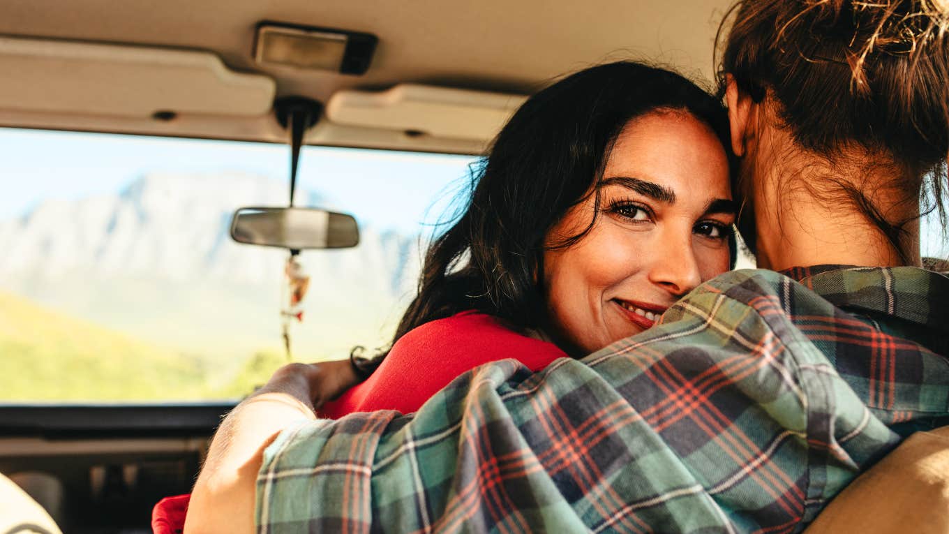 The Scientific Reasons Why So Many Women Believe Men Are In Love With Them (When They're Not) Woman smiling believing partner is in love