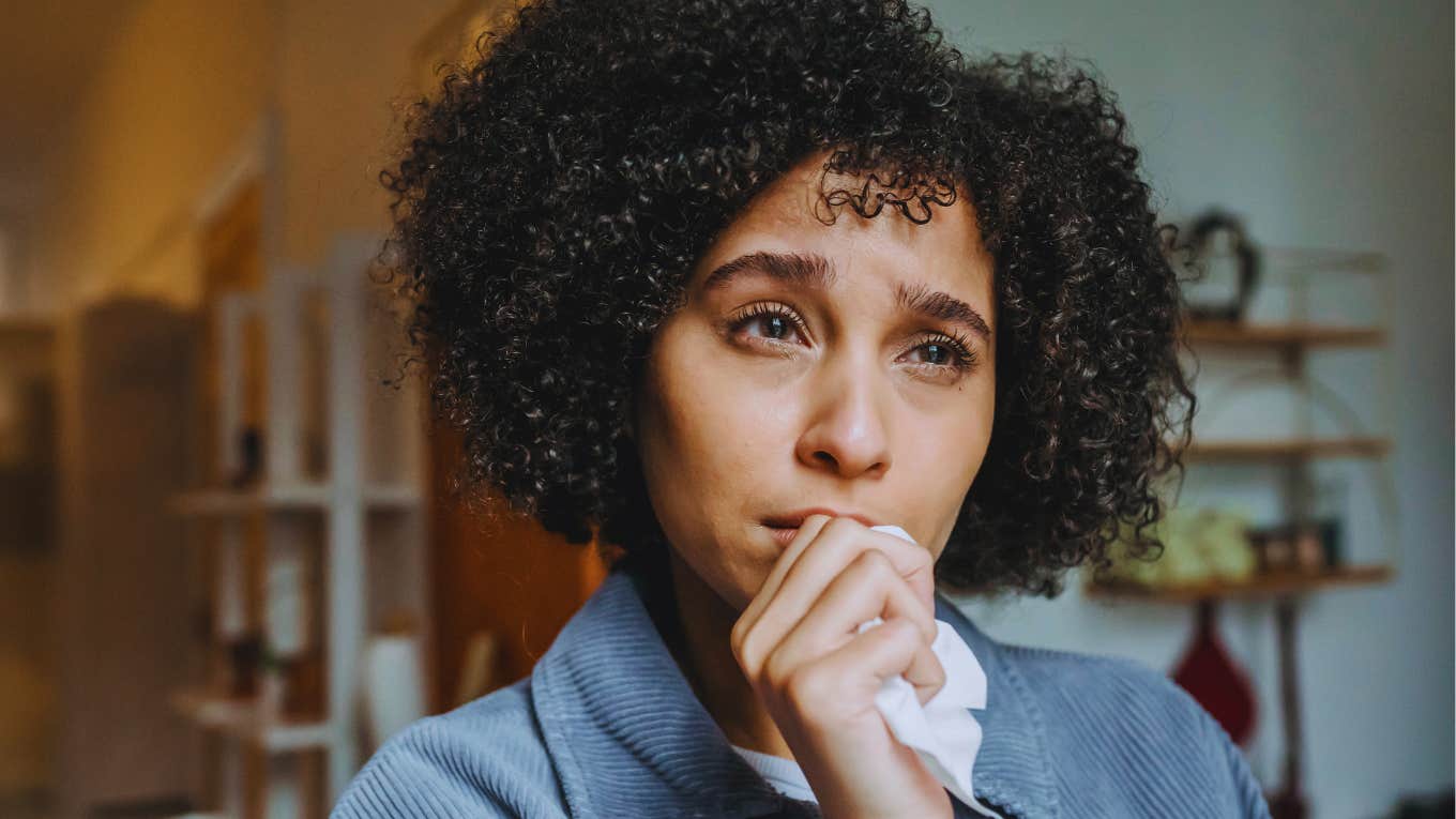 15 Habits That Signal A Partner Is Cheating And Can't Be Trusted, According To A Betrayed Spouse Woman is upset and notices the signals her partner is cheating and can't be trusted.