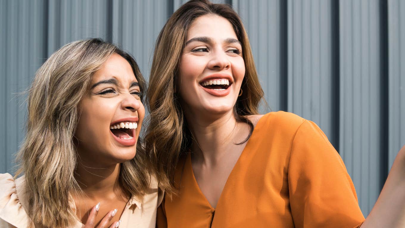 Signs Someone Is Faking A Connection With You Two women with fake smiles together