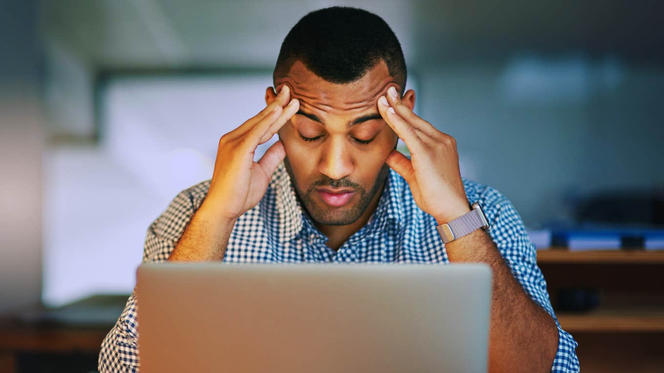 I'm A Nurse Of 30 Years — I Would Never Ignore These 7 Early Signs Of Toxic Stress Man in front of computer is experiencing toxic stress.