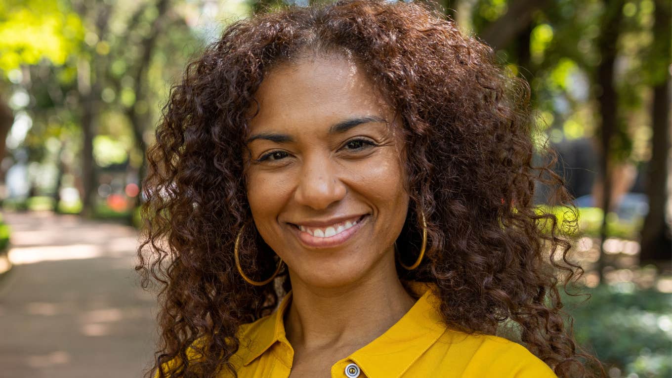 Signs Your Mind Works Faster Than The Average Person, According To Psychology intelligent smiling woman in the park