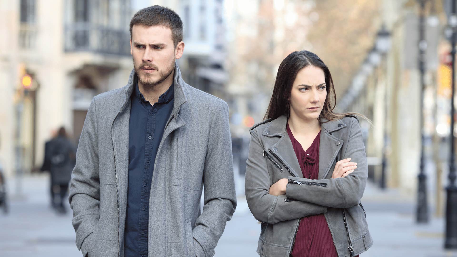 couple walking side by side ignoring each other