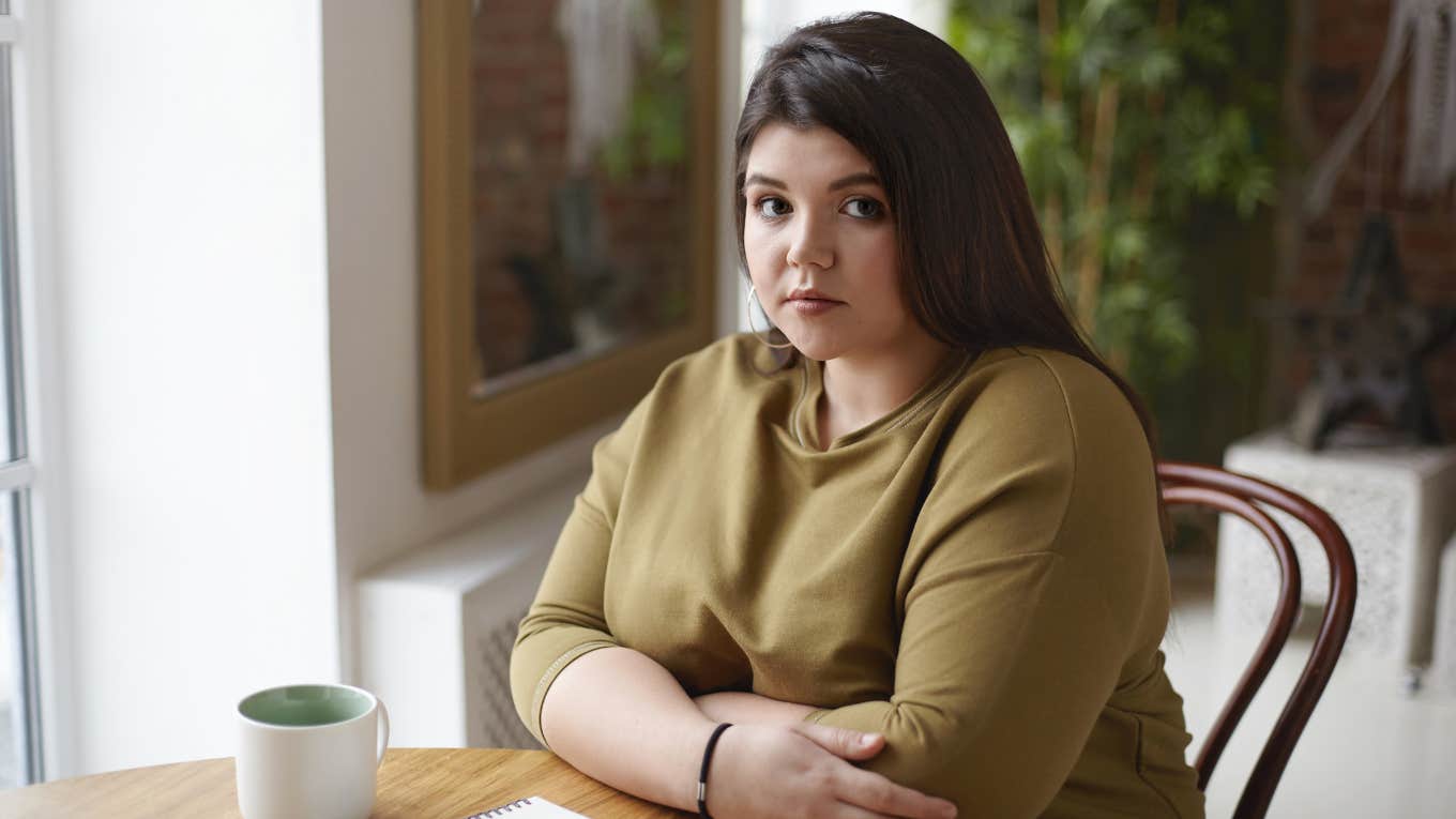 Woman Breaks It Off With Her Fiancé Because He's Embarrassed By Her Weight Gain Sad woman sitting at table drinking coffee