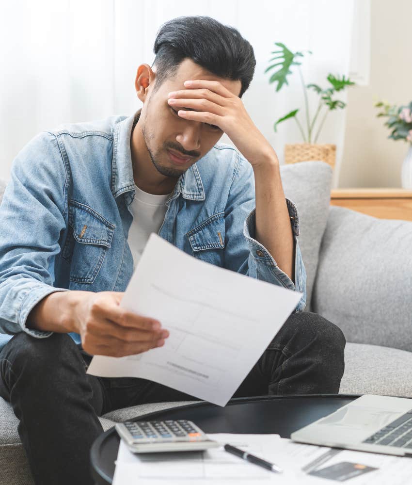 Young man looking over his financials to try and buy a house