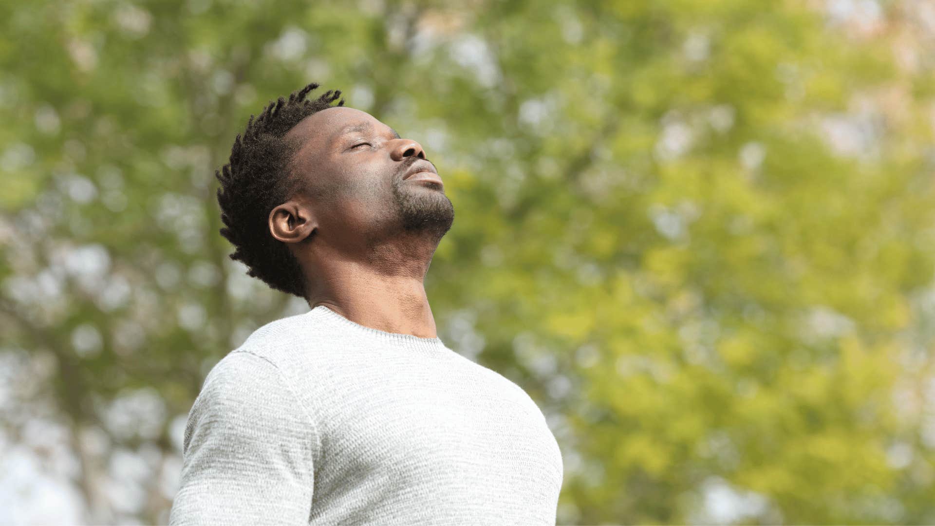 man breathing deeply outdoors