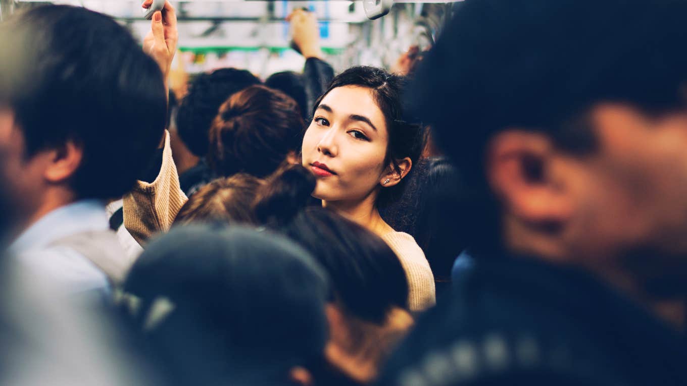 If You Believe These Lies, You're Never Going To Live The Life You Want Woman standing out in a crowded bus, living the life she wants