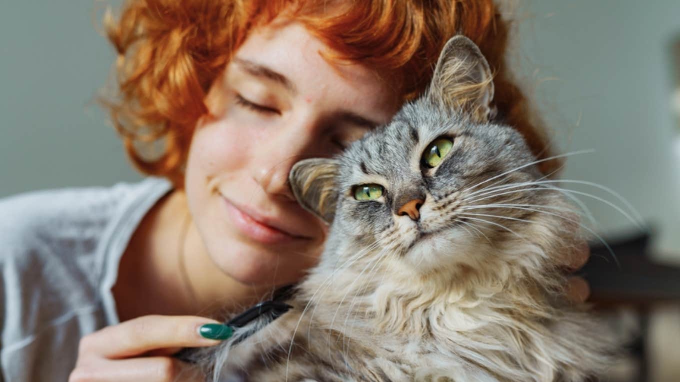 Boss And Coworkers Are Unhappy That Remote Employee Keeps Missing Scheduled In-Person Events Due To A Sick Cat woman cuddling with cat