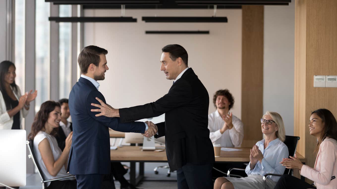 Career Educator Shares Unspoken Trait People Who Get Promoted Easily Always Have boss congratulating promoted employee with staff applauding