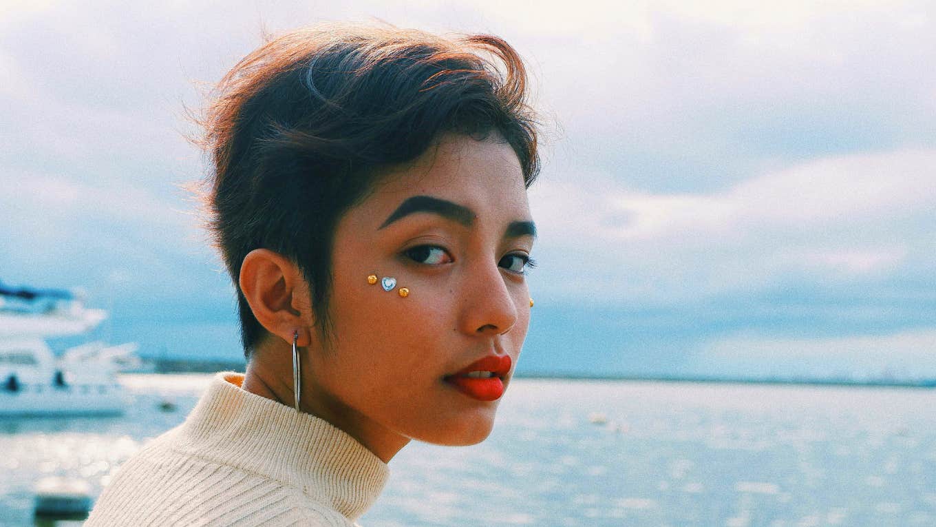 Compliments That Are Actually Insults In Disguise serious looking woman by the water