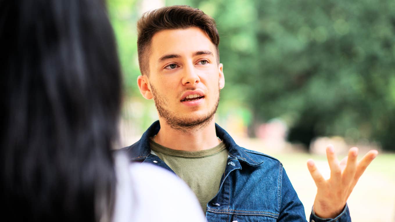 Confident Ways To Talk To Someone Who Intimidates You, According To Psychology Man talking to intimidating woman