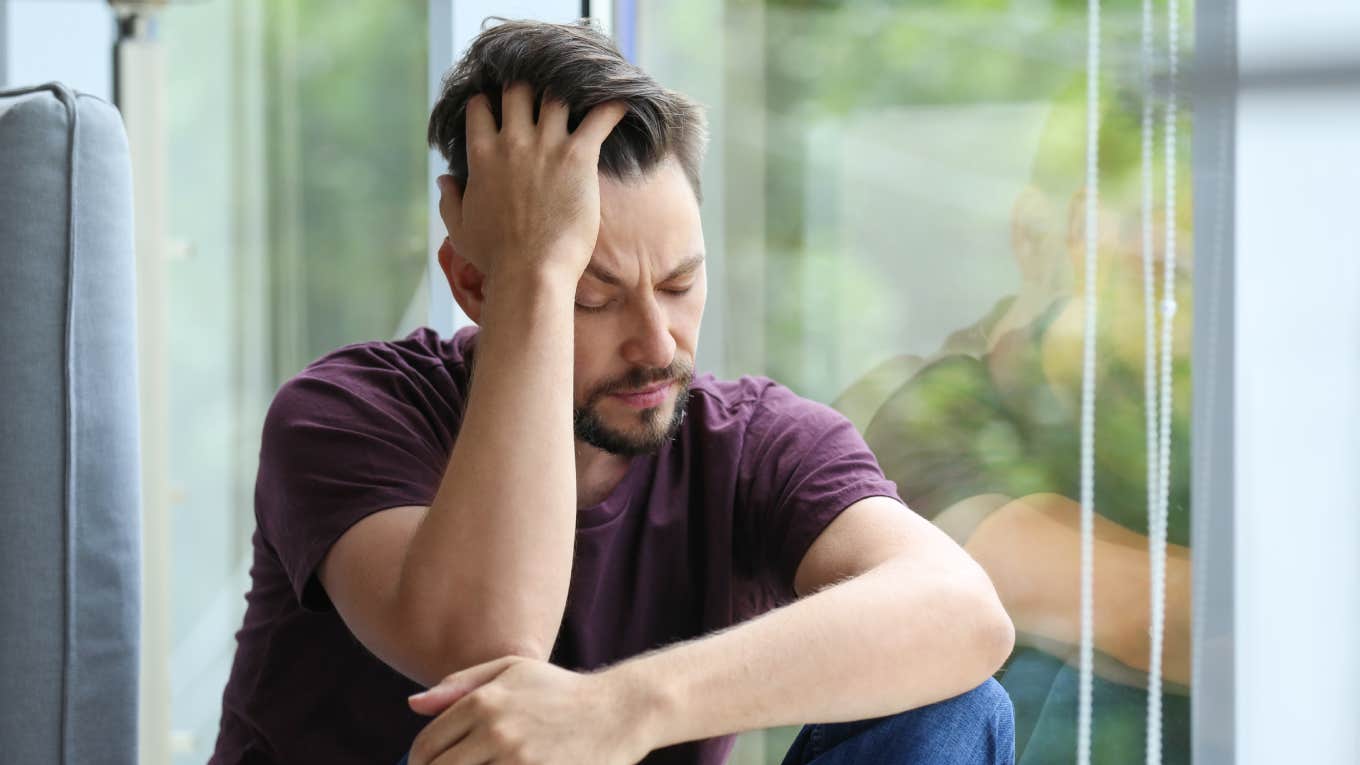 Dad Explains How A Pumpkin In The Grocery Store Made His Empty Nester Blues Feel Real lonely and depressed man near window at home