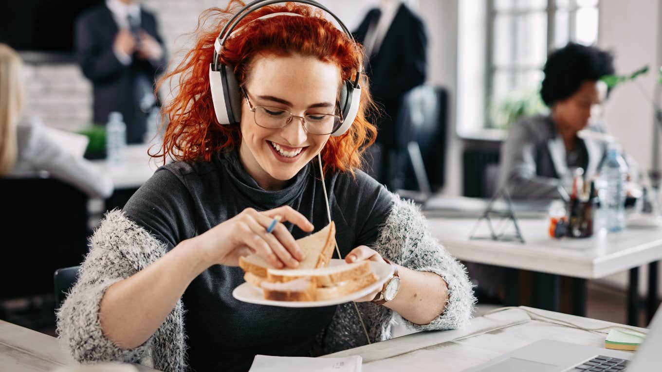 Employees Given 'PB&J' Day Instead Of Their Annual Raise Employee eating a PB&J in her office instead of getting a raise.