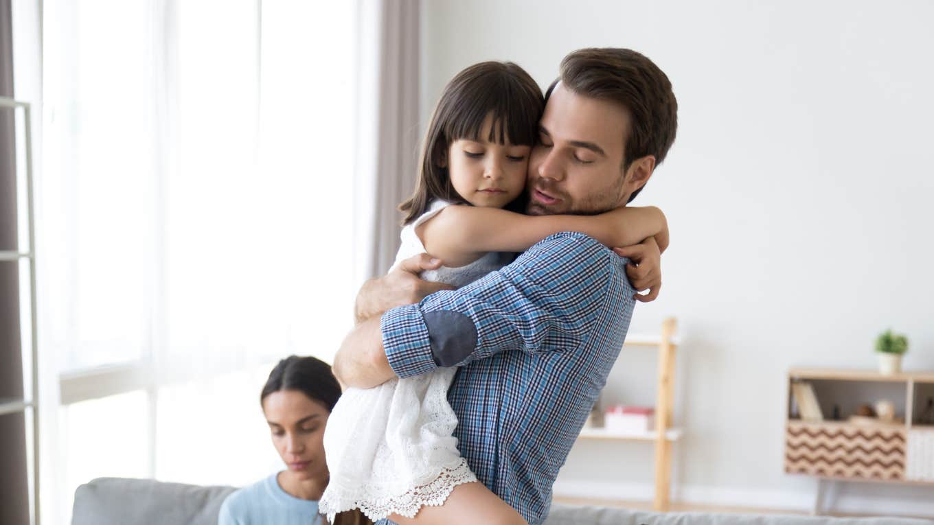 Husband Concerned That His Wife Yells At Their Daughter Every Day Dad hugging daughter after being yelled at by mom