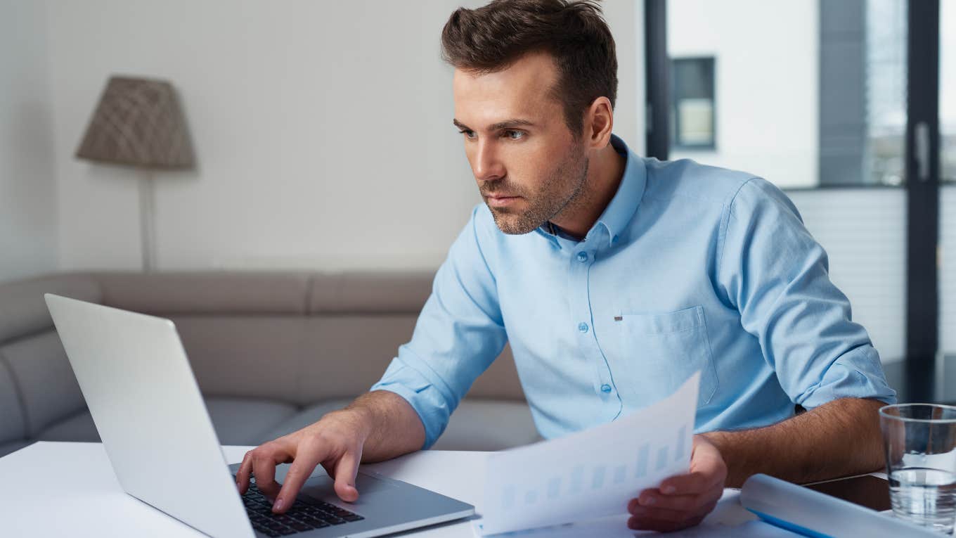 Man Says It's Unrealistic For People To Be Financially Stable In Their 30s Young man at computer trying to budget and pay bills