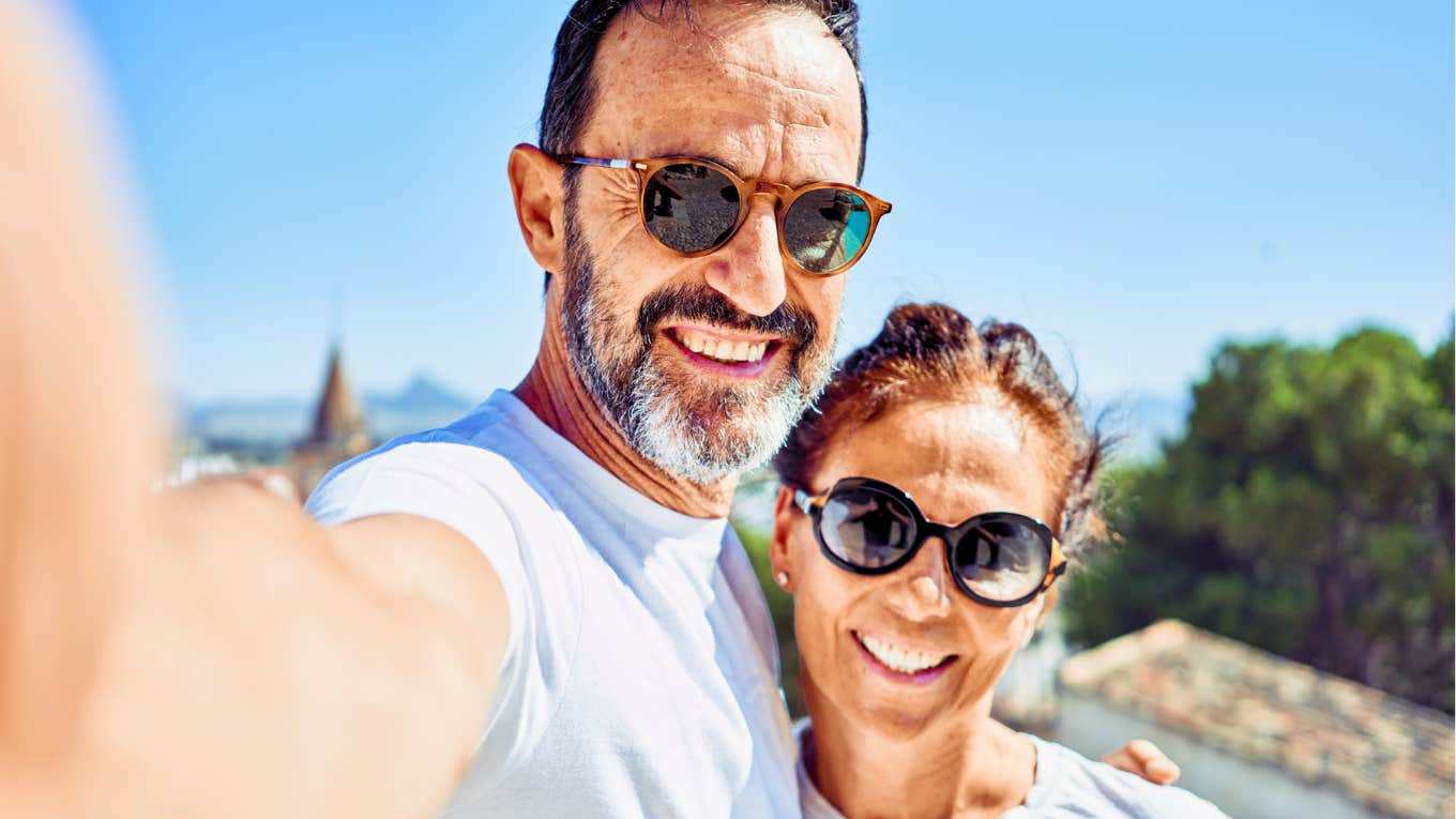 Quiet Signs A Man Really Loves You, According To Psychology Quiet man in love, with arm around his partner,