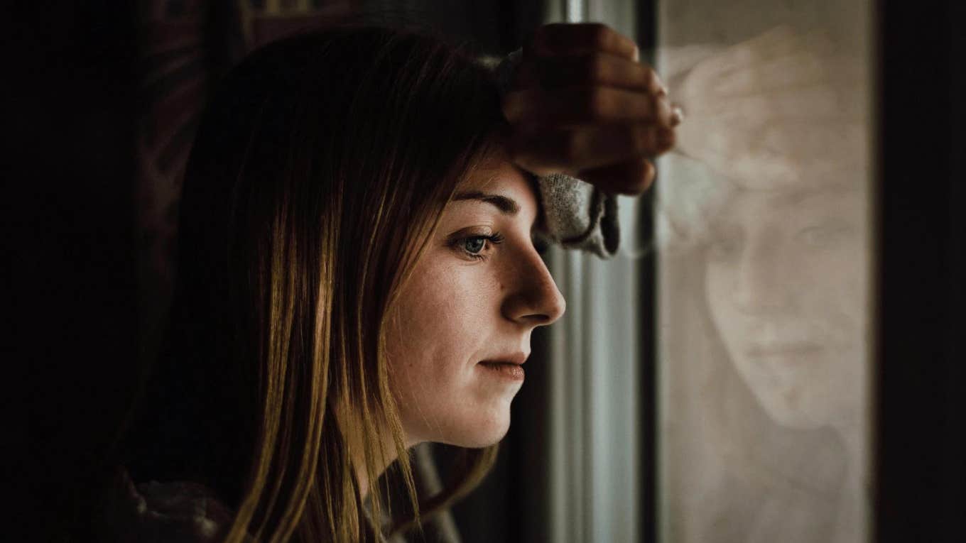 Signs You Grew Up In A Family Without Much Money And It's Affecting You Now sad woman thinking about childhood