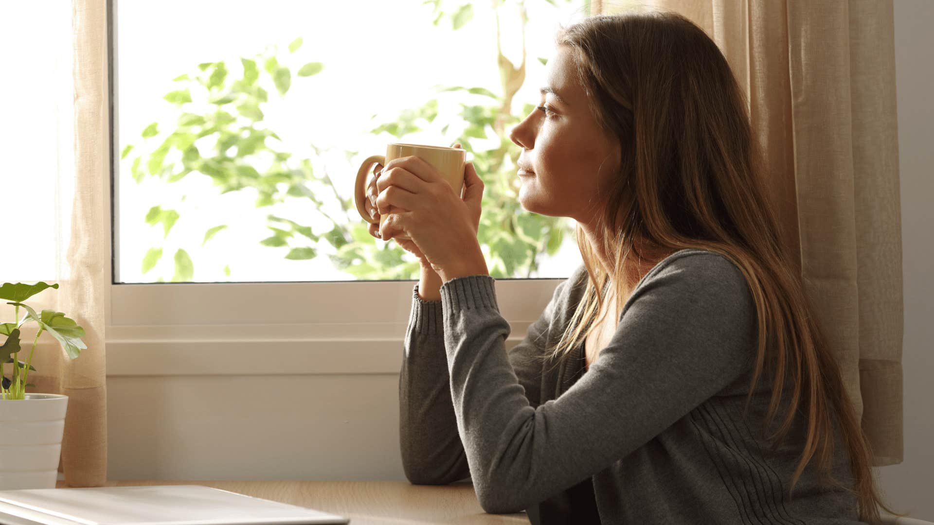 woman looking out the window