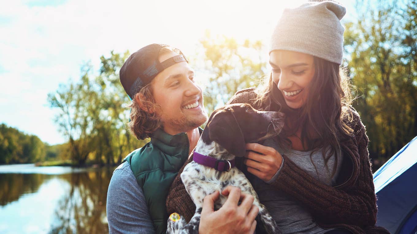 Survey Shows Americans Can No Longer Afford To Have Pets happy couple snugging their puppy
