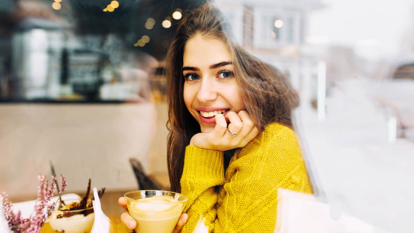 Little Ways To Show Someone You're Interested -- Without Saying A Word Smiling woman, showing man outside she's interested