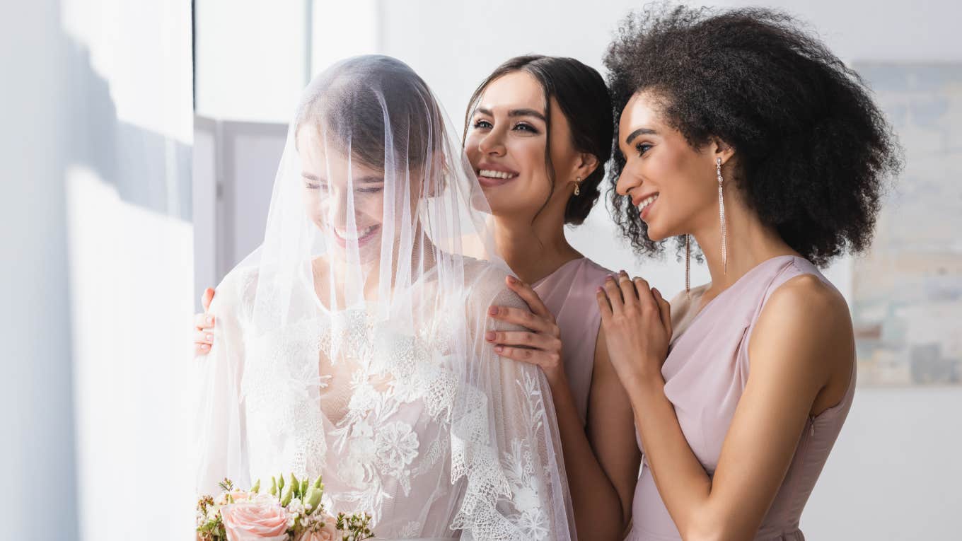 Woman Says We Should Normalize Saying No To Being In Someone's Wedding Party happy bride holding wedding bouquet near smiling bridesmaids