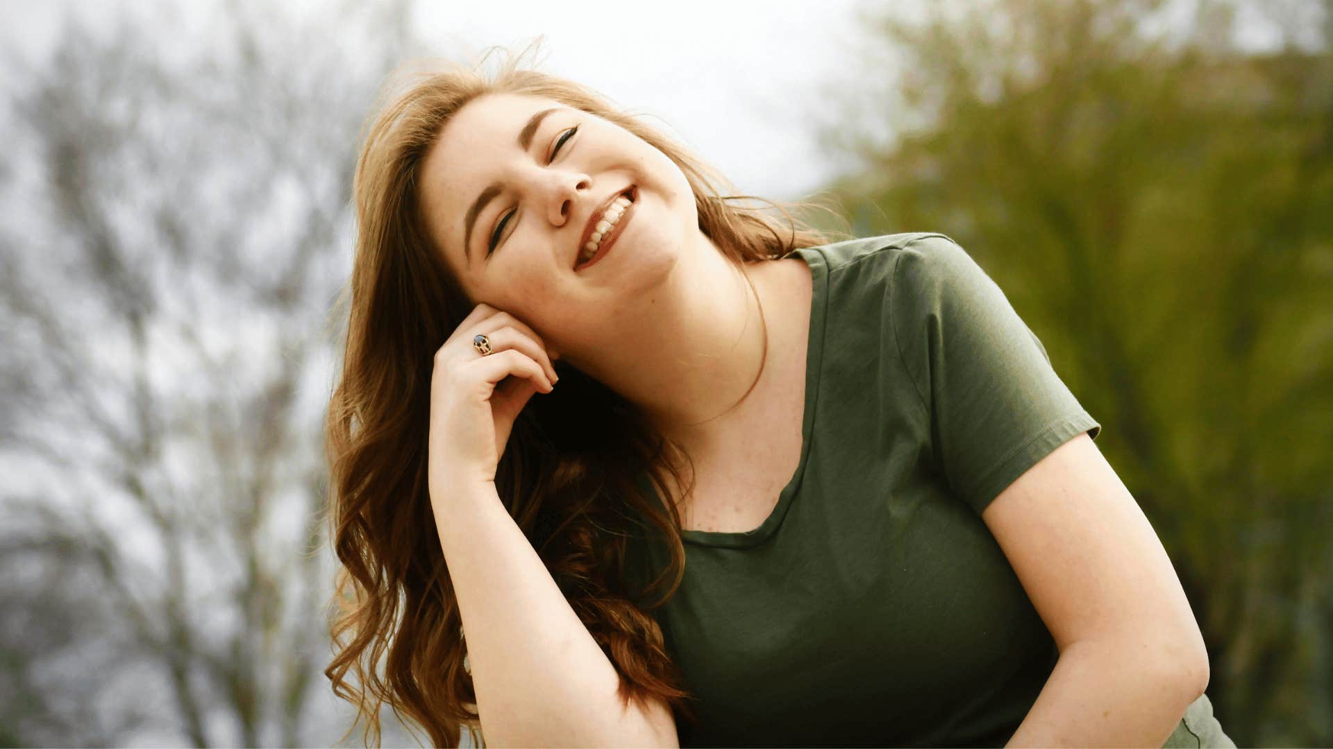 young woman smiling outdoors