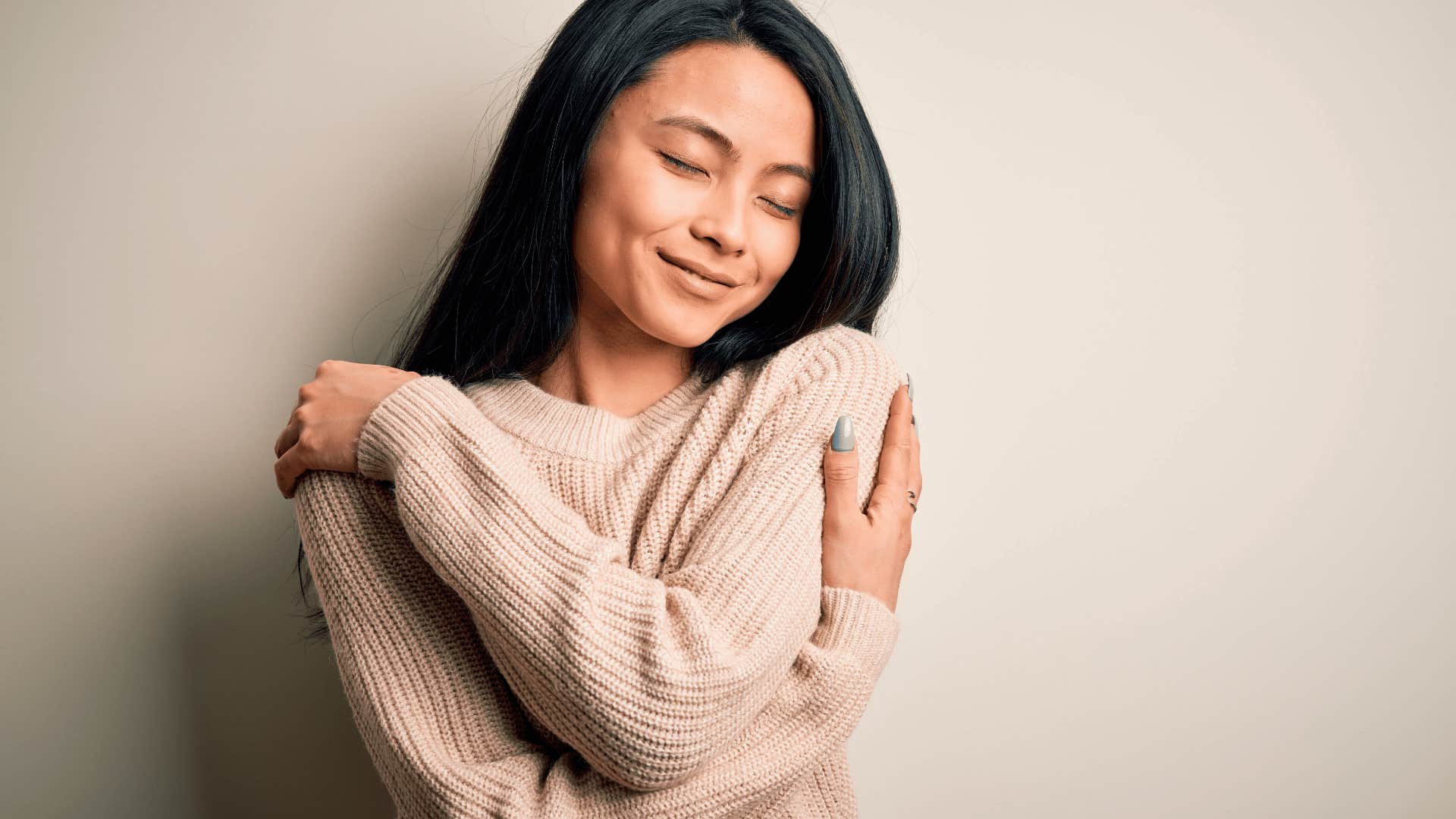 young woman hugging herself
