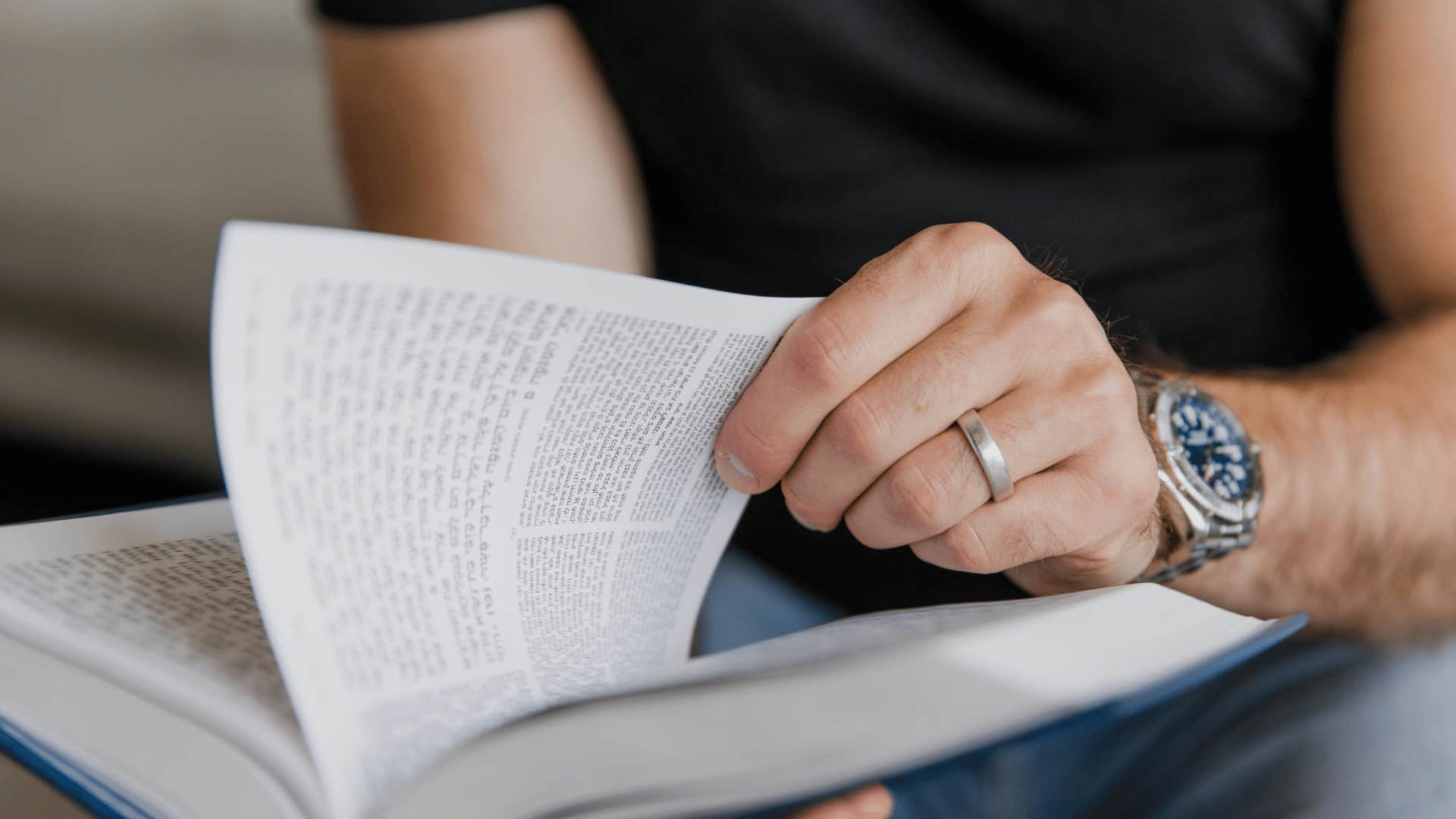 man turning page of a book