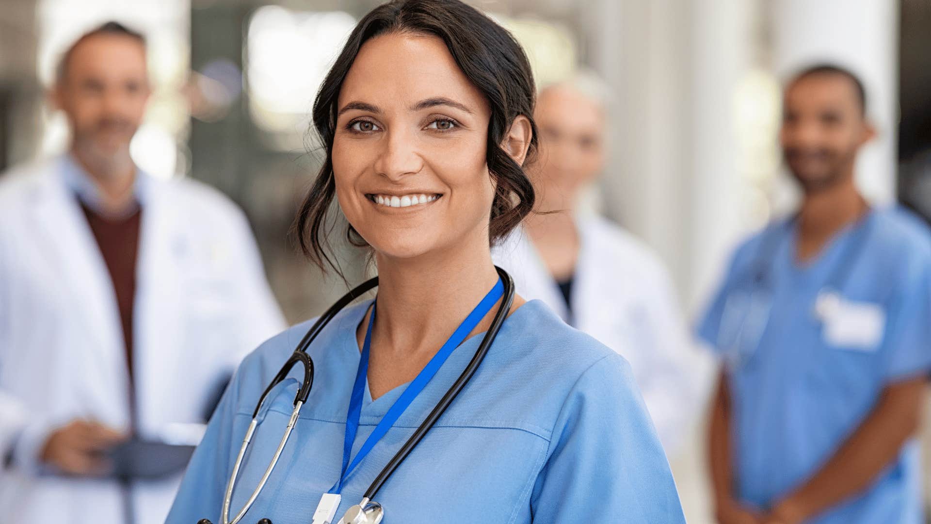 smiling woman wearing scrubs