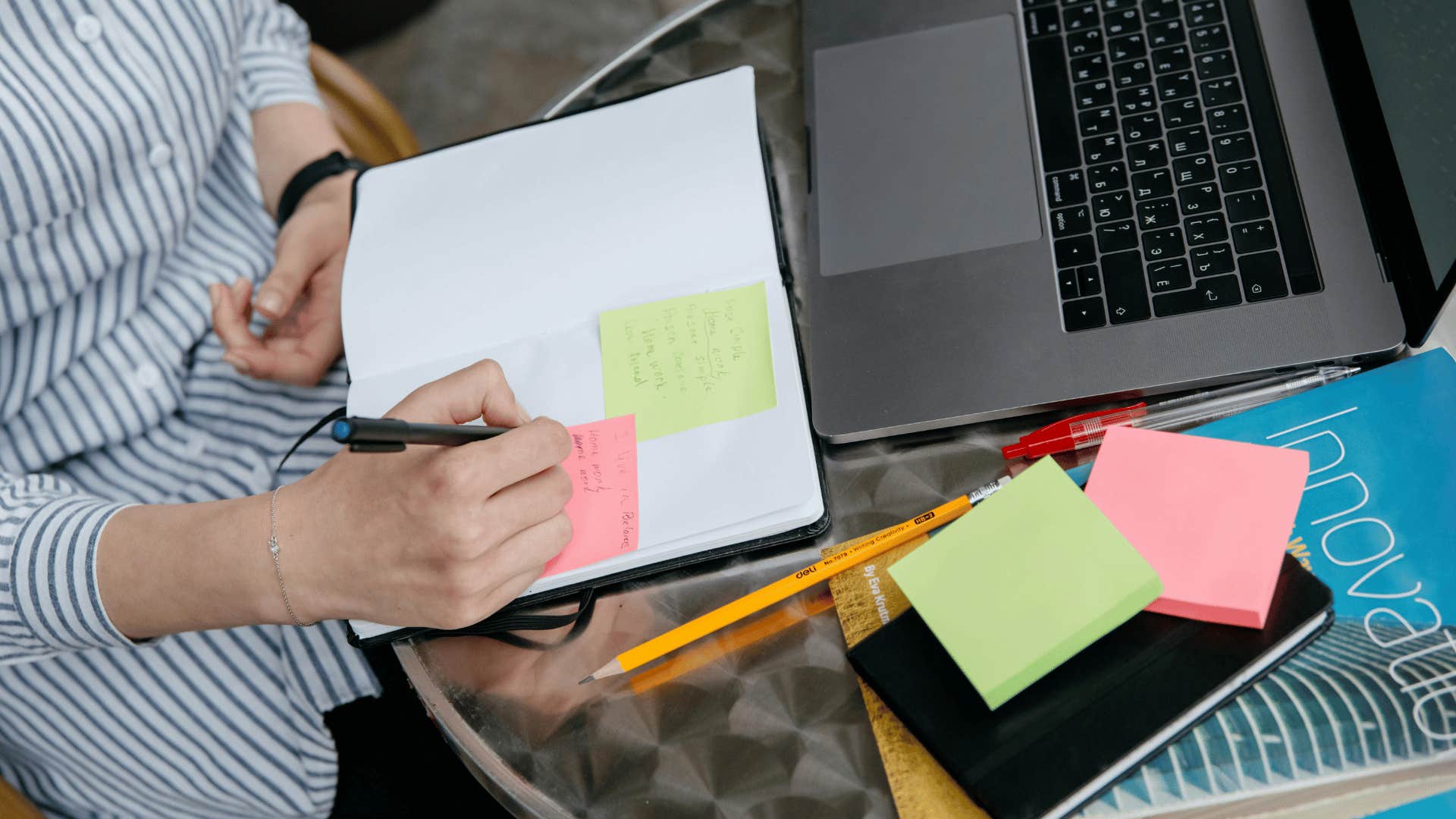 woman writing on sticky notes