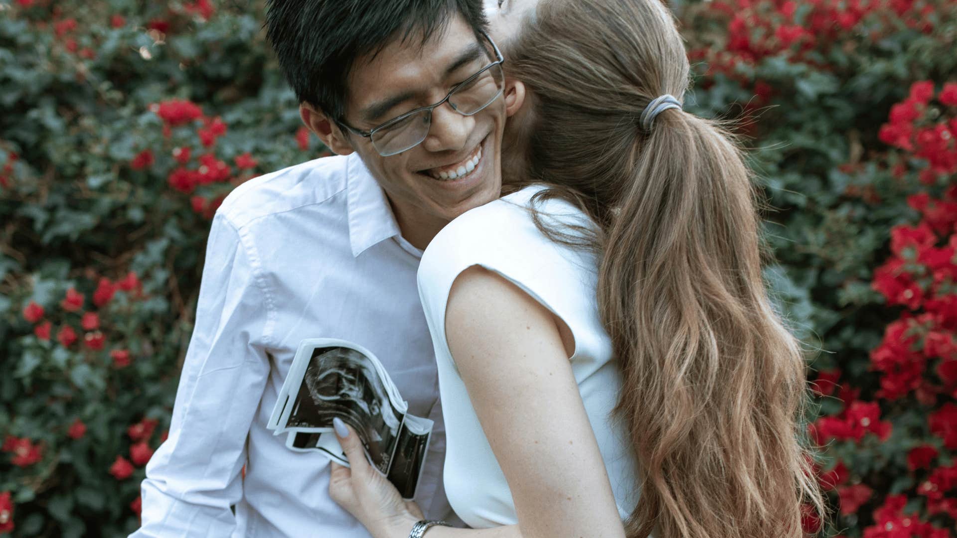 happy couple excited about sonogram pictures