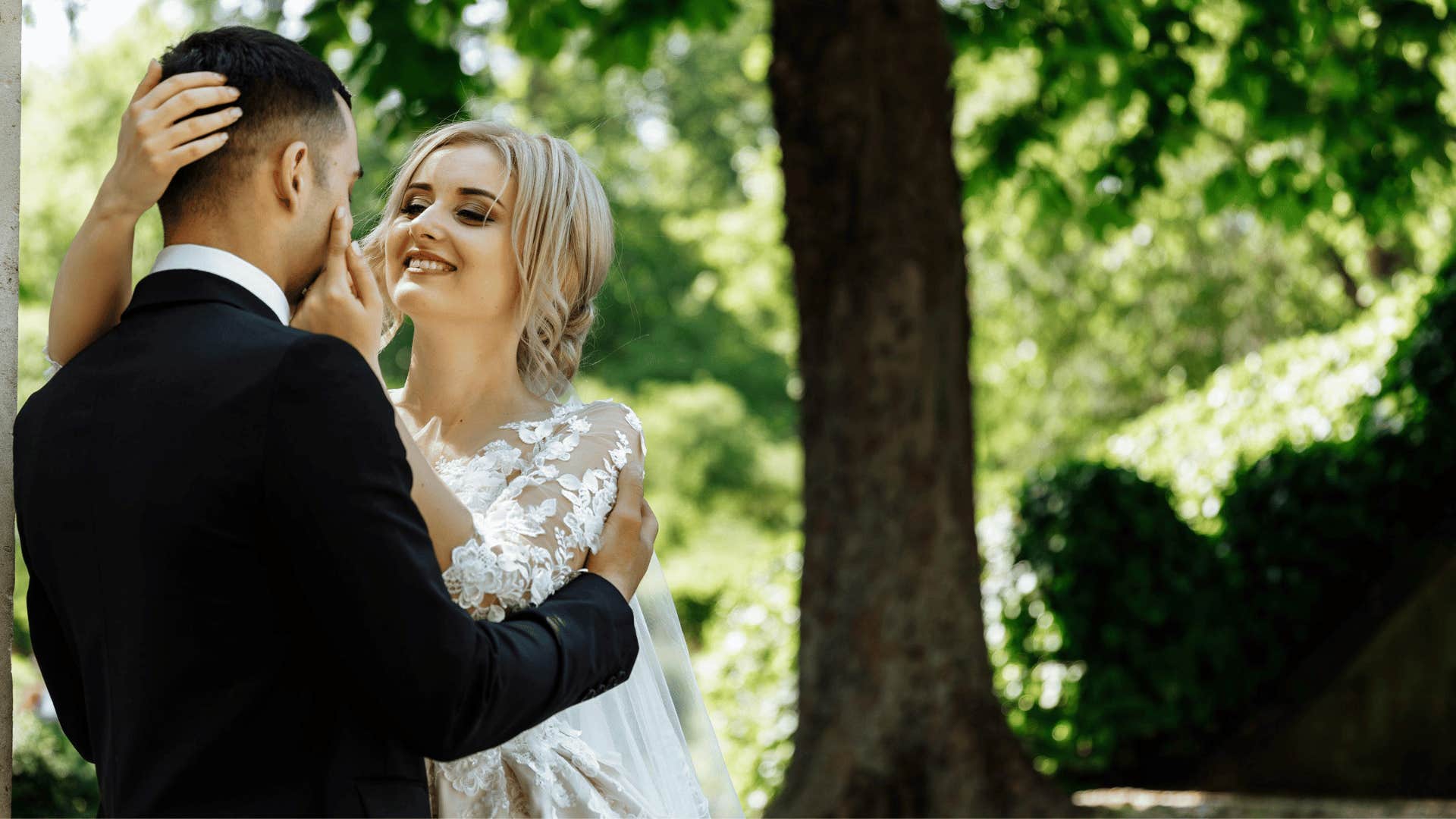 groom and bride smiling at each other