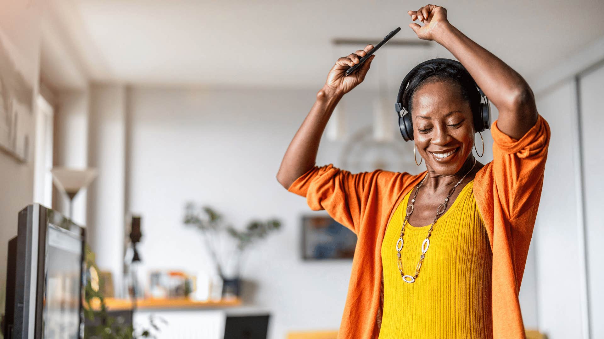 woman dancing while wearing headphones
