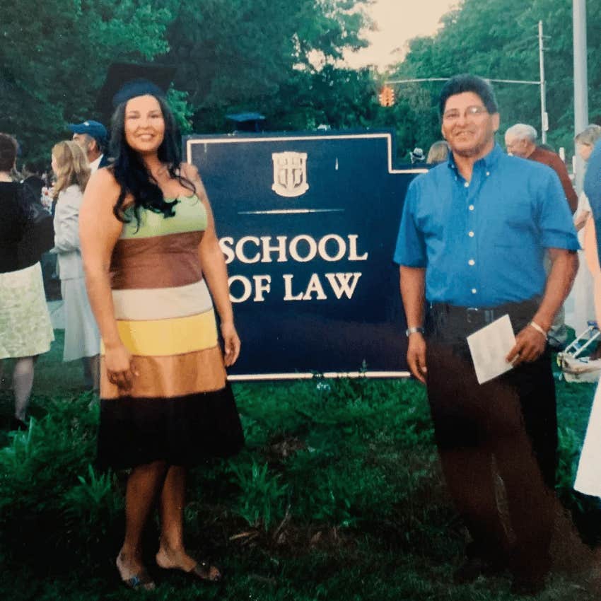 author at graduation posing with her dad