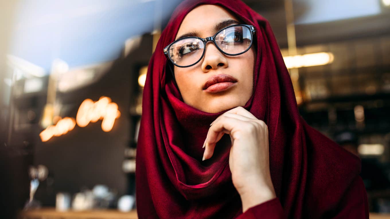 Before You Schedule Couples Therapy, Psychologist Says To Ask Yourself These Questions Woman thinking about scheduling a couples therapy session.