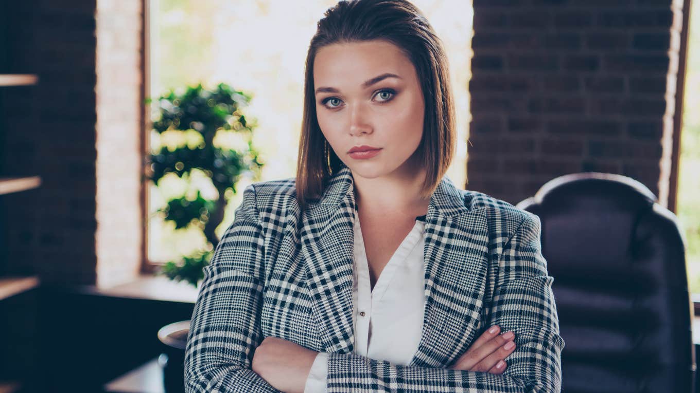 Delusional Beliefs Narcissistic Bosses Have About Themselves And Their Workers serious boss in an office with her arms crossed