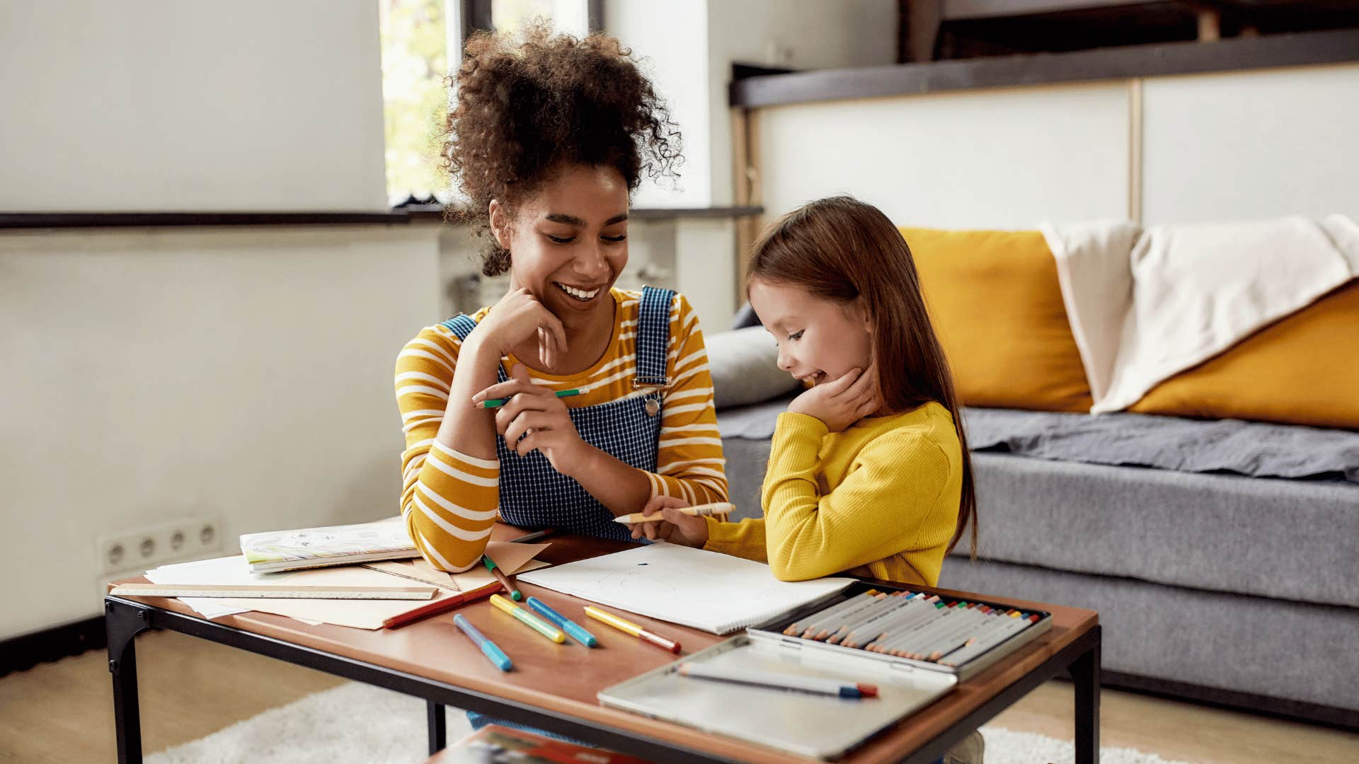 woman and child drawing together