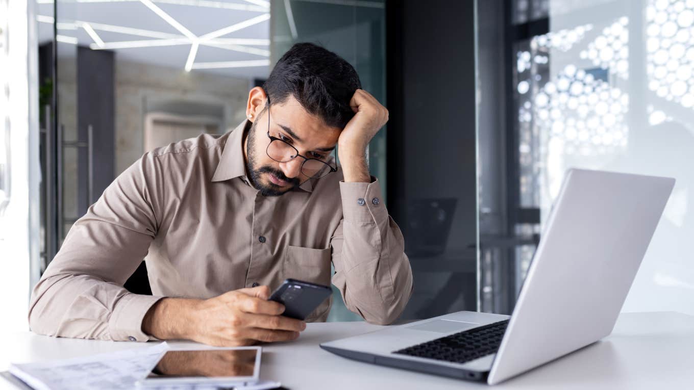 Employee Accused Of Being Selfish For Not Switching Vacation Days For A Coworker Going On Her Honeymoon Upset businessman reading news on phone in office