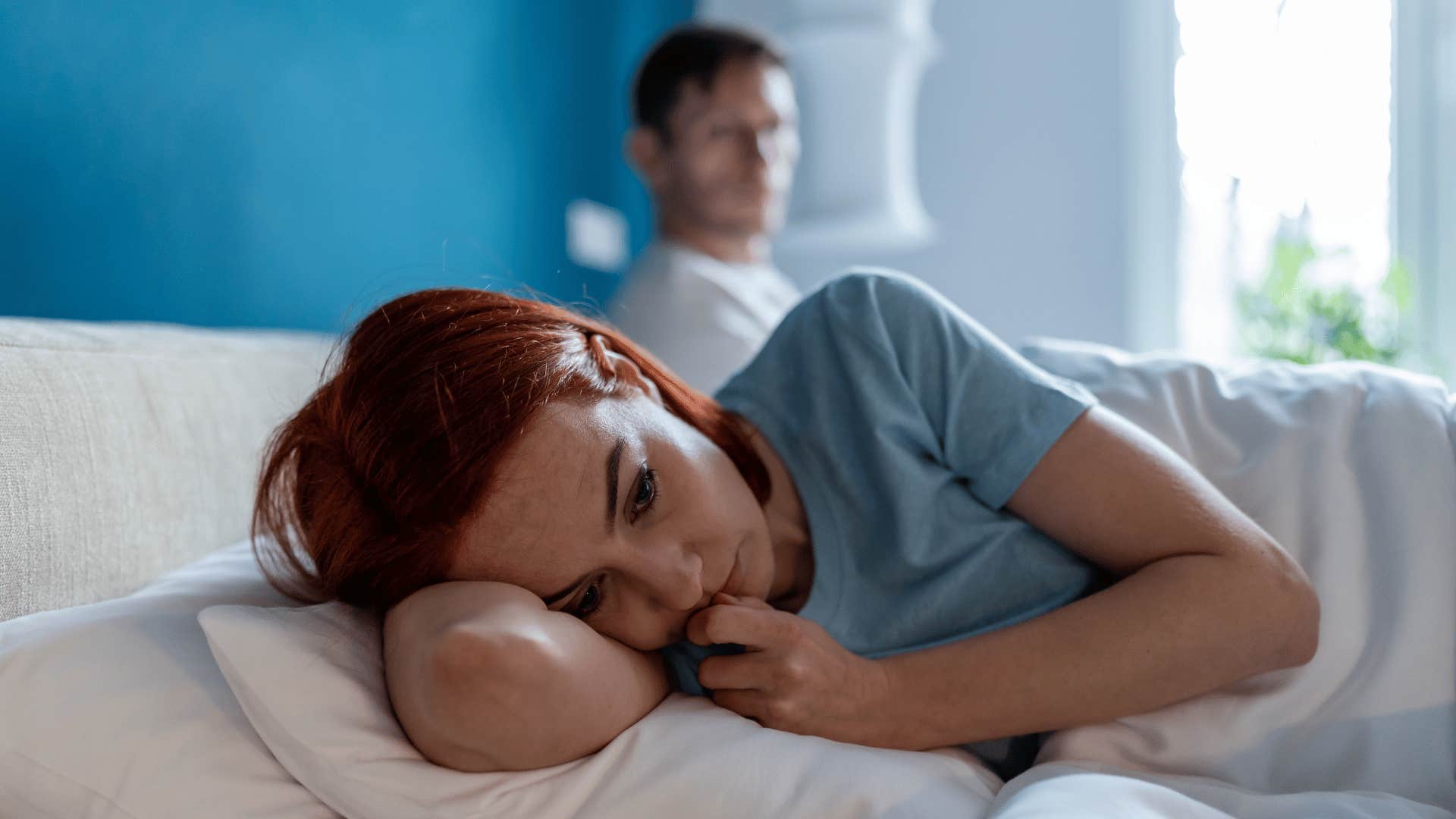 sad woman in bed
