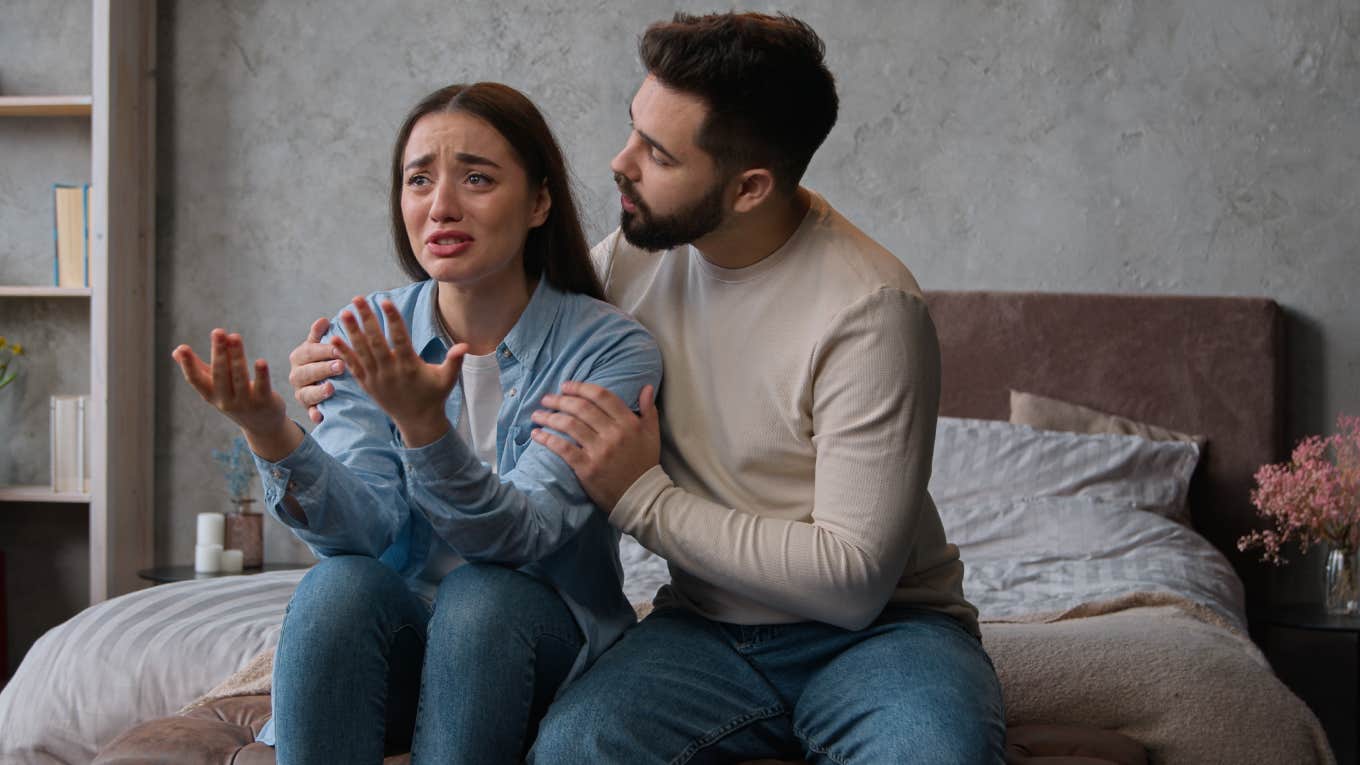Husband Questions If He Did Something Unforgivable By Telling His Wife Life Would Be Better Without Her husband trying to calm down crying wife while sitting on bed