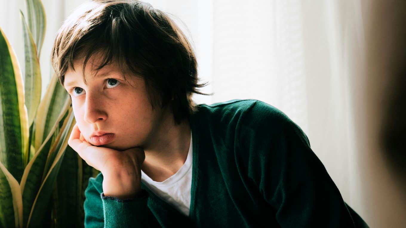 Lies You Grow Up Believing When You Were Emotionally Neglected As A Child Young boy sitting alone in room, emotionally neglected.