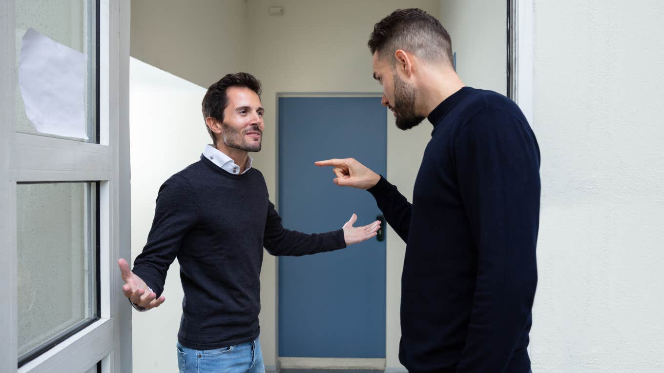 Man Calls Brother 'Greedy' For Requesting He Start Paying Rent two men arguing in front of a door
