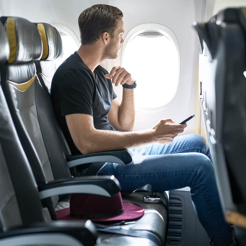 Man seated in coach on airplane