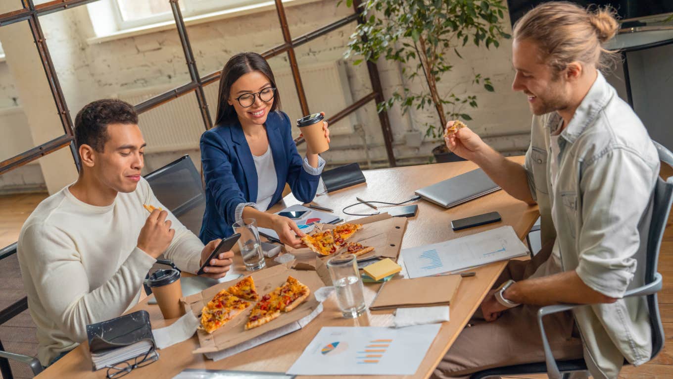 Meta Fired Employees Who Used Their Daily Food Delivery Stipend To Buy Groceries business team having break and eating pizza while being on job discussion in office boarding room.
