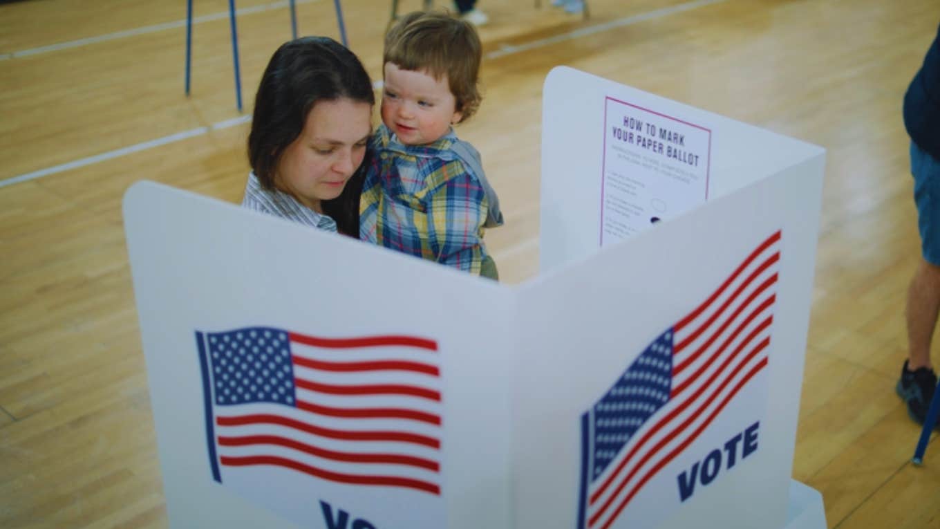 Mom Of 3 Says Poll Worker Tried To Stop Her From Voting Because She Brought Her Kids With Her To The Polling Place woman voting with son