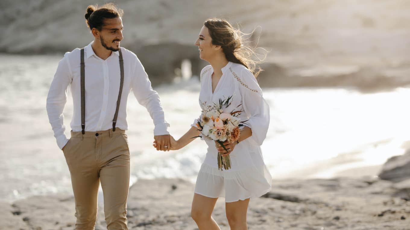 Newlyweds Surprise Bride’s Grandparents With Heartfelt Gift After Missing The Wedding newlyweds on a beach after wedding ceremony