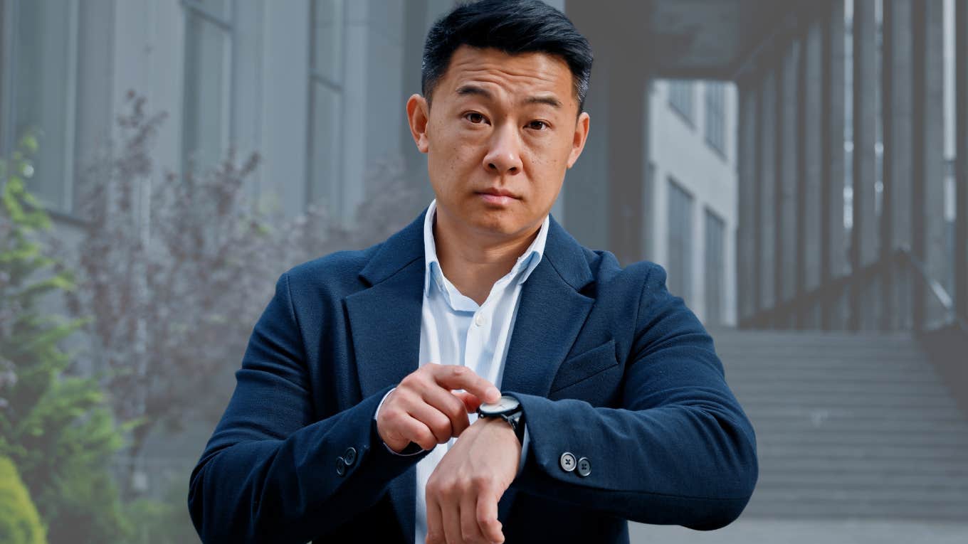 Phrases Bad Bosses Say Way Too Often Bad boss looking stressed and pointing at his watch.