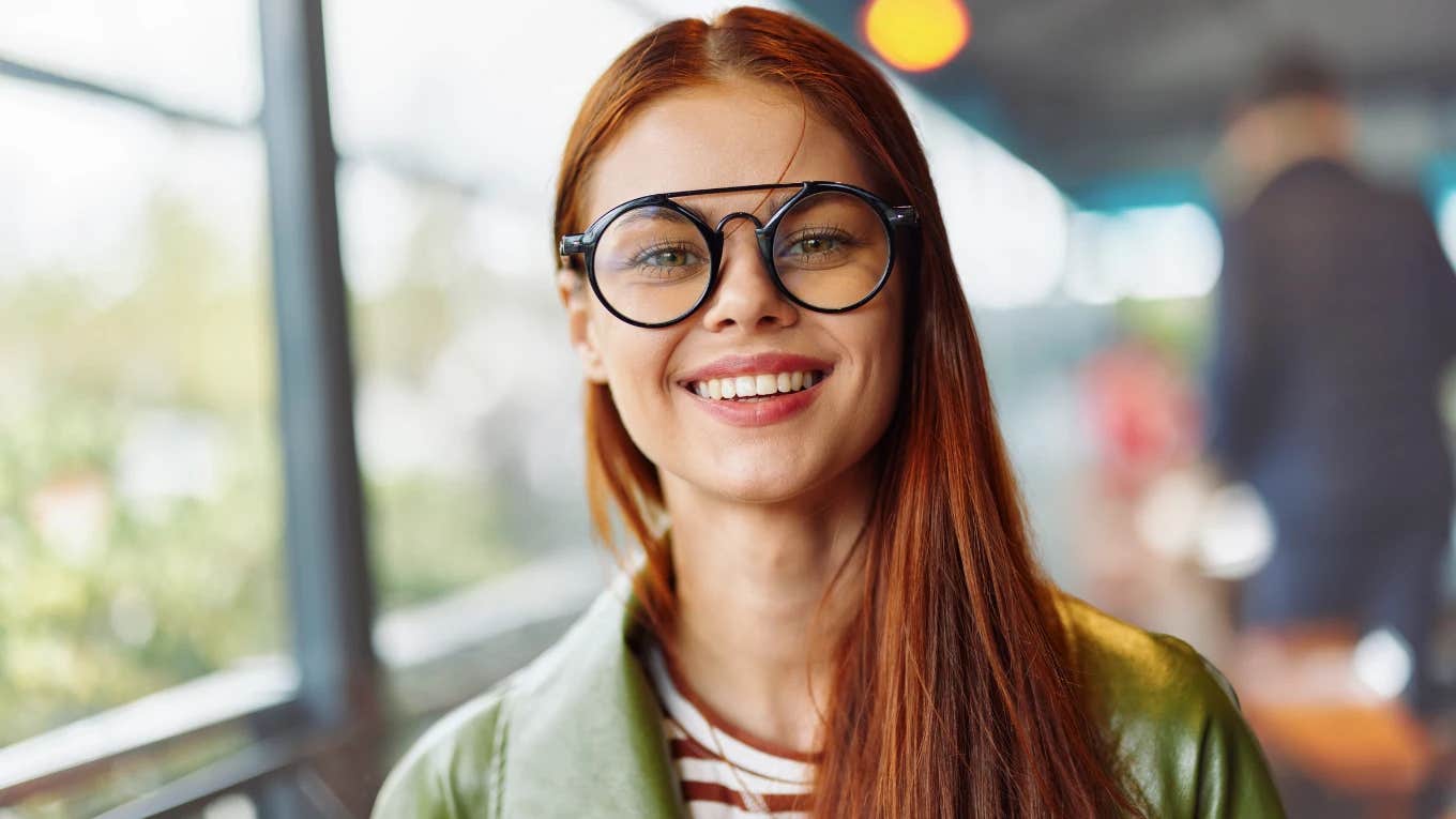 Phrases People Who Are Good At Small Talk Always Use red headed woman with glasses smiling