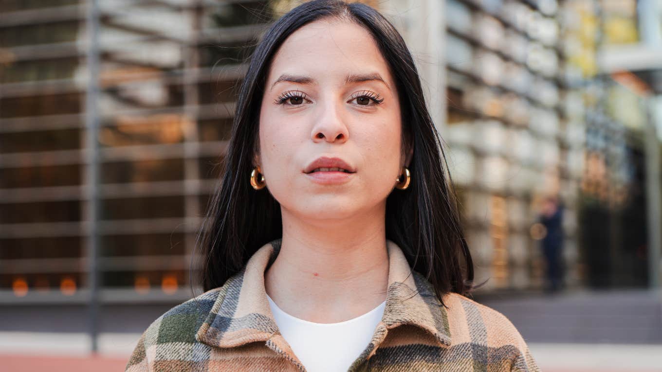 Phrases To Remove From Your Vocabulary To Avoid Sounding Like A People Pleaser serious woman in a flannel jacket