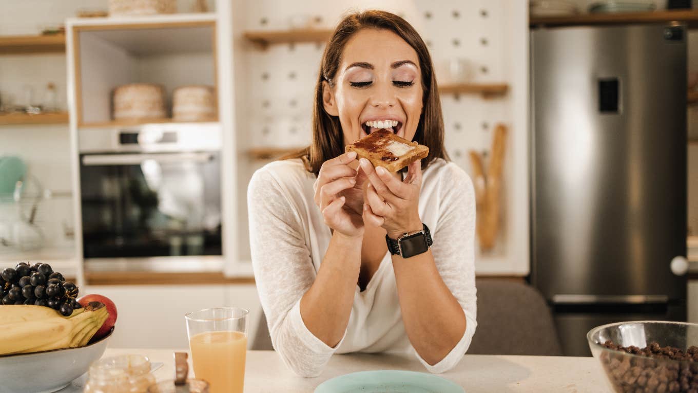 8 Poverty Foods People Still Eat As Financially Comfortable Adults Happy woman eating a poverty food