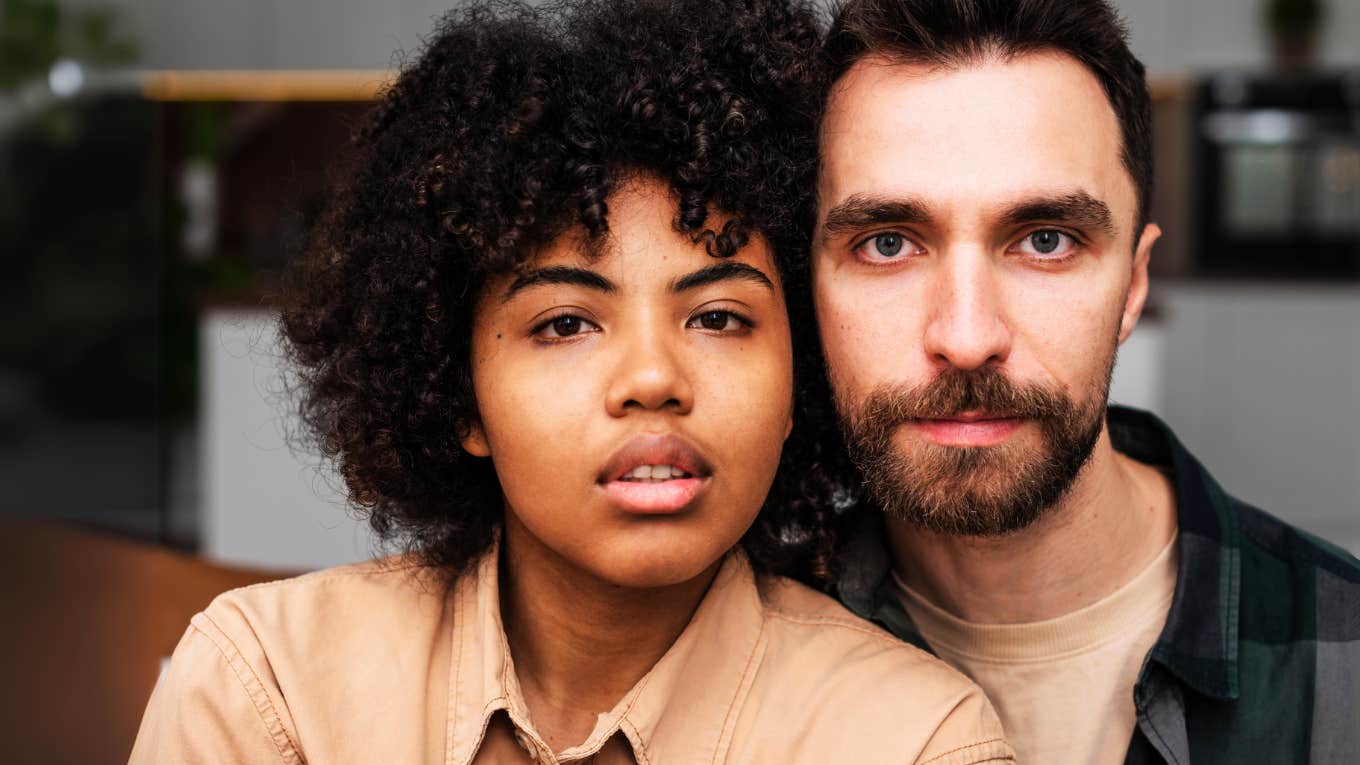 Relationships That Survive Cheating Have These Small Things In Common Couple in relationship that survived cheating, sitting next to each other.